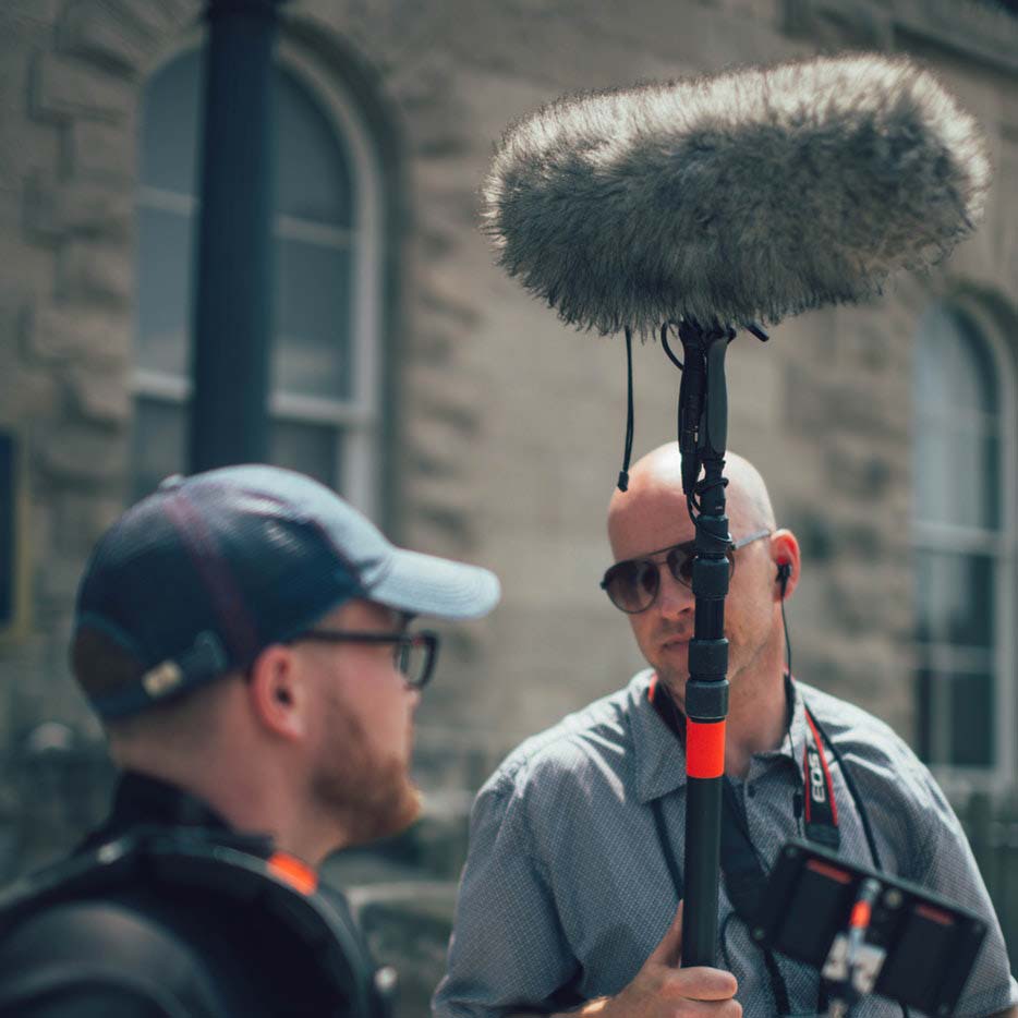 Boom operator and a camera operator — Photo by Nik MacMillan on Unsplash